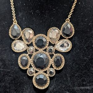 black and clear stone statement necklace, often referred to as a bib
